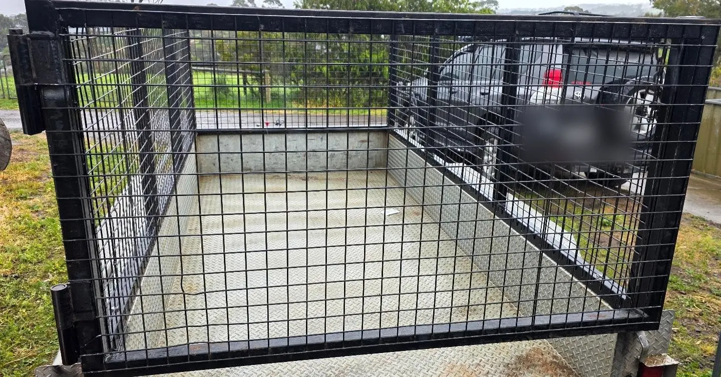 Finished black mesh trailer cage on a checker-plate box trailer